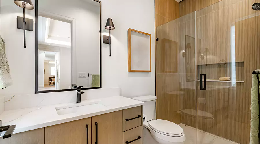 Modern bathroom renovation with grey shaker vanity and glass walk-in shower